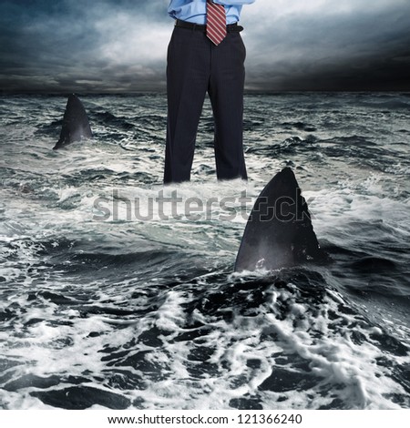 Businessman surrounded by shark