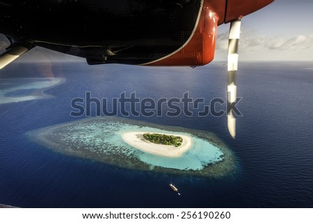 view from a plane of a small island and resort, Maldives