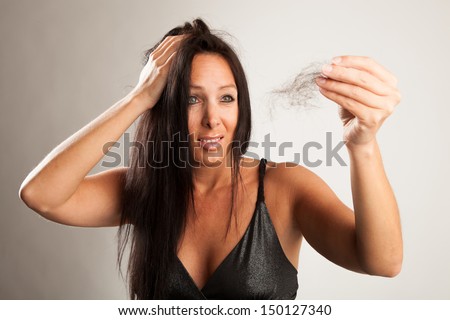 Woman with tufts of hair in front of white background