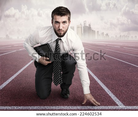 Attractive business man with a notebook is ready to run