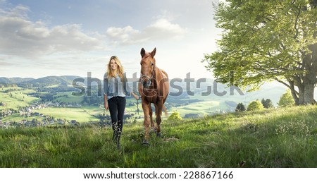 Beautiful girl with a horse in the german mountains