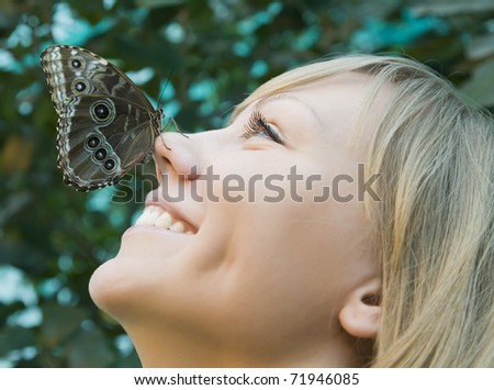portrait of a girl in which this butterfly is sitting on the nose