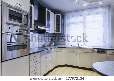 Modern Empty Kitchen With Stainless Still Appliances.