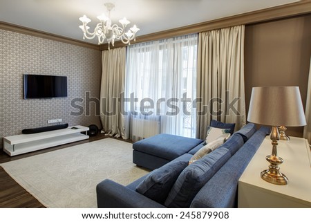 Interior of a modern living room with blue sofa in luxury mansion
