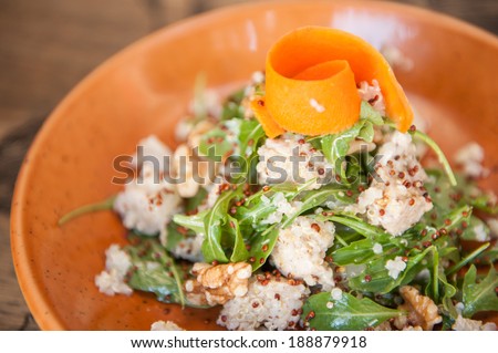 Close up shot of Quinoa salad with walnuts, rocket lettuce, seeds and carrot