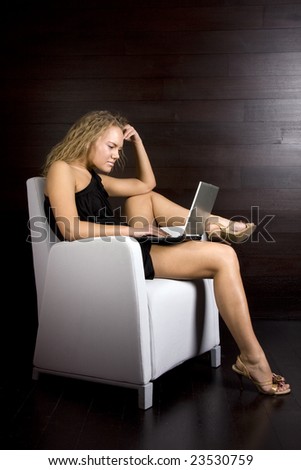 pretty blonde woman working in the hotel on the laptop