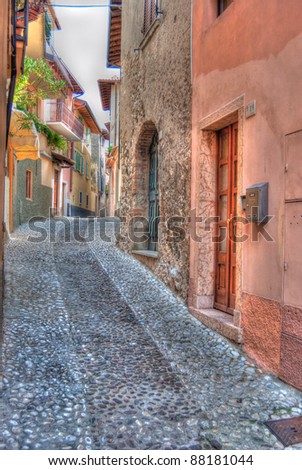A typical Italian back street with cobbled roads and colorful buildings found in Tuscany, italy.