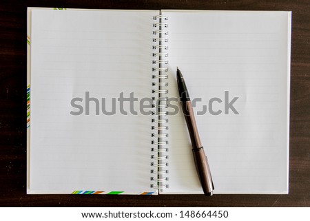only open a blank white notebook and pen on the desk