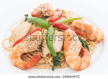 A STIR FRIED SPICY SPAGHETTI WITH SEAFOOD on white background