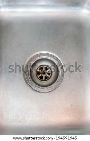 Stainless steel sink plug hole close up background
