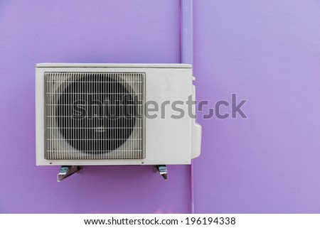 Air compressor on purple wall