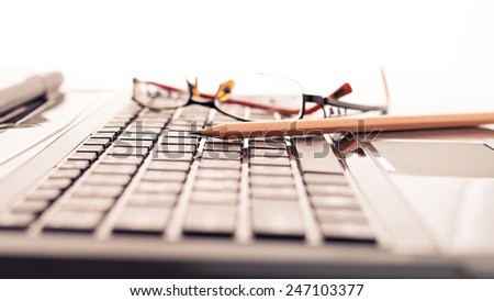Modern business desk with laptop, pencil and glasses. Modern business concepts