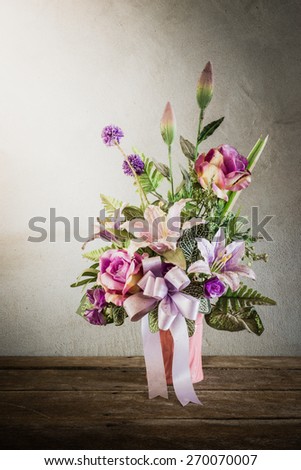 Still life with a beautiful bunch of Flowers with cobweb on wooden table. vintage tone