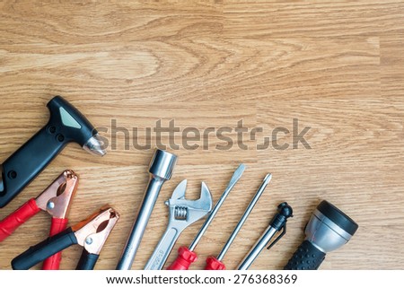 group of emergency rescue equipment in the car on wooden background, maintenance concept