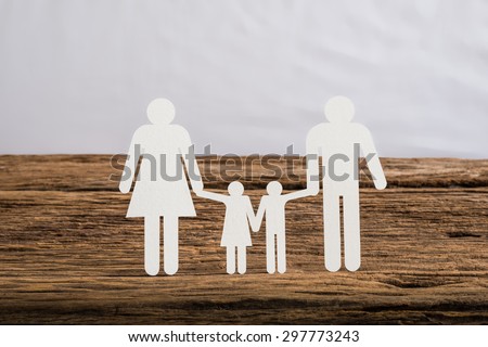 paper chain family symbolizing on wooden table. love family concept