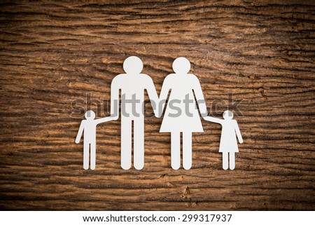 paper chain family symbolizing on wooden background. love family concept