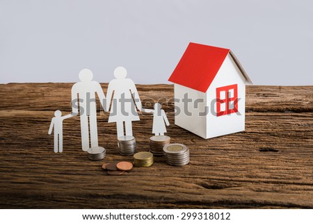 paper chain family symbolizing and house on wooden table. love family concept. Real estate loan concept