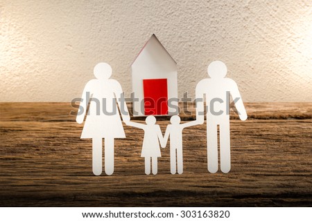 paper chain family symbolizing and house on wooden table. love family concept