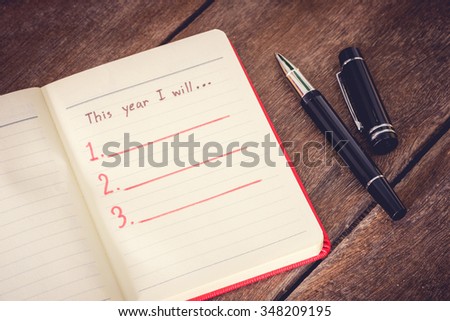 New Year Resolution, Empty list. on wooden table