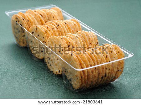 Cookies in a plastic transparent box on green