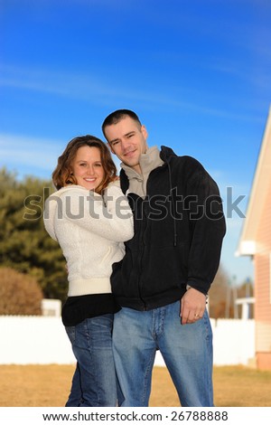 Young couple in a court yard of the house