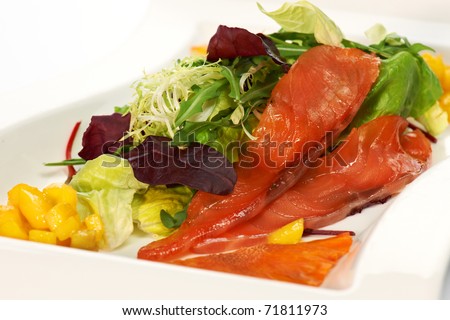Slices of red fish with salad leaves