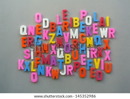 Scrambled letters together in a colorful background