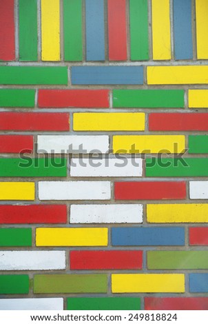 Brick wall texture full of lively colors green white yellow blue and red
