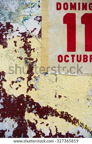 Photo of urban collage background or typography paper texture. Spanish text reads: Sunday eleven October