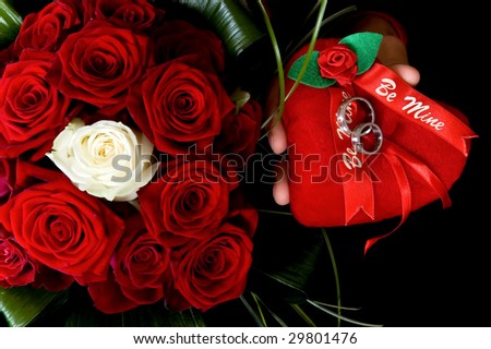stock photo wedding bouquet of red and white roses with rings on a heart