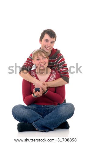 Two casual dressed teenagers, teenage man and woman with jewel in box. studio shot, reflective surface