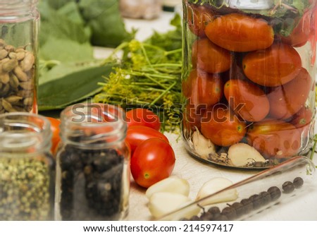 Fresh tomatoes. Homemade tomatoes. Canned tomatoes. Tomatoes in a glass jar with spices.