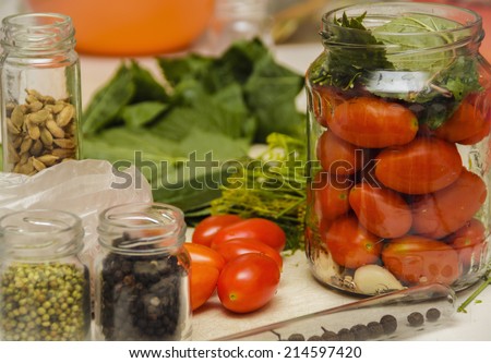 Fresh tomatoes. Homemade tomatoes. Canned tomatoes. Tomatoes in a glass jar with spices.
