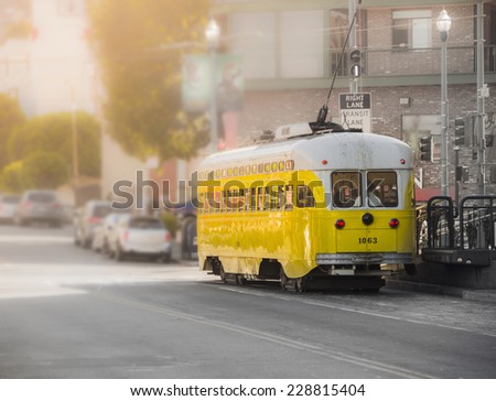 Vintage Tram Trolley car moves through the street in San Francisco. City street view.