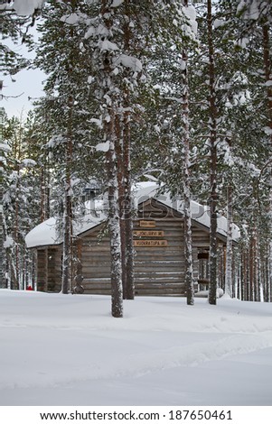Winter Finnish snowy landscape with wooden cabin