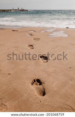 Footprints in the sand, at the beach, Cova do Vapor, Portugal