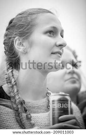 Traena, Norway - July 10 2014: portrait of a young fan at the concert of the Norwegian folk rock band Hekla Stalstrenga at the Traenafestival, music festival taking place on the small island of Traena
