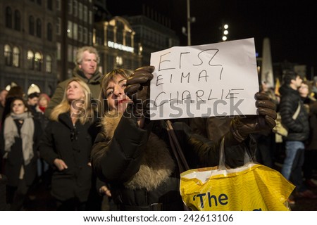 Amsterdam, The Netherlands, January 08 2015: demonstation in solidarity with the attack against Charlie Hebdo in Paris, France on 07 January, woman holding a sign saying \