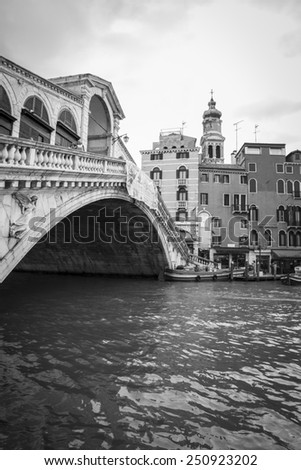 VENICE, ITALY - JANUARY 2015: Black and white view of the Grand Canal with famous Rialto Bridge in black and white, just before the Carnival kicks off - travel and lifestyle