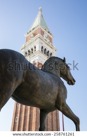 view of the Campanile with one of the horse statue of the San Marco Basilca in front, San Marco Square, Venice, Italy