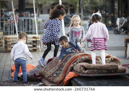 Amsterdam, The Netherlands, 12-14 Septembre 2014, during West\'ival, an open air free Cinema and culture festival on Mercatorplein. Children playing on the square before the screening starts
