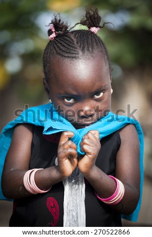 SENEGAL - November 5, 2013: Little shy Senegalese girl living on the island of Sipo in the Sine-Saloum Delta, near Toubacouta