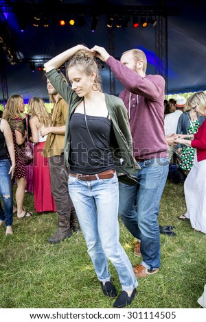 Amsterdam, The Netherlands - July, 5 2015: people dancing salsa during the concert of Colombian band LA-33 at Amsterdam Roots Open Air, cultural festival held in Park Frankendael on 05/07/2015