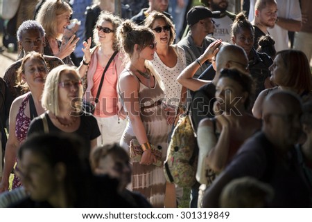 Amsterdam, The Netherlands - July, 5 2015: beautiful pregant young woman in the audience crowd during Amsterdam Roots Open Air, a cultural festival held in Park Frankendael on 05/07/2015