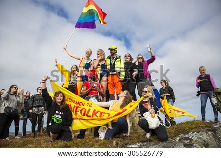 Traena, Norway - July 11 2015: group of colorful people participating in the smallest gay Pride in Europe during Traenafestival, music festival taking place on the small island of Traena.