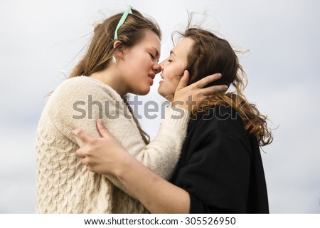 Traena, Norway - July 11 2015: two young women kissing during the smallest gay Pride in Europe during Traenafestival, music festival taking place on the small island of Traena.