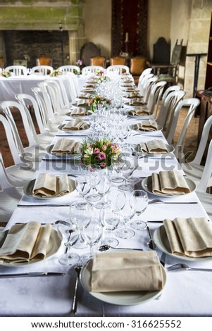 Table set for an event party or wedding reception in a old medieval castle room