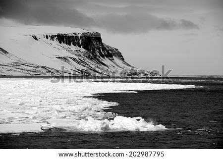 Black and white cliffs in Arctic Ocean
