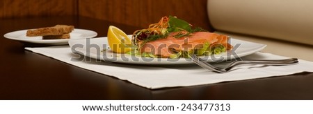 Panorama of smoked salmon platter and toast