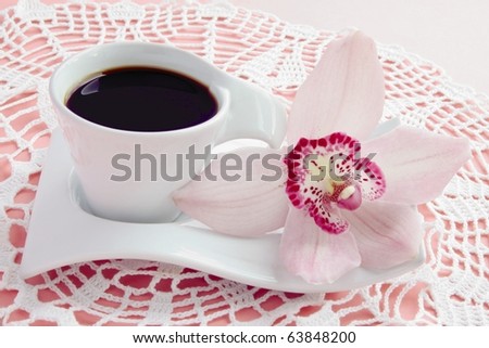 coffee and orchid on pink